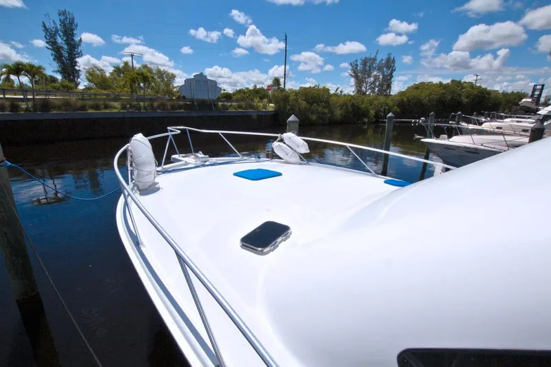 Slide: The Image of 1998 Luhrs 36 Convertible yacht cruising on a scenic waterway. - 9