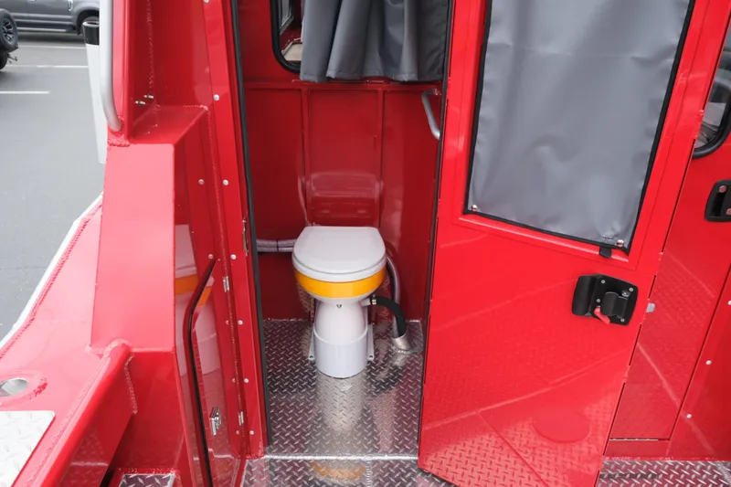 Slide: The Image of Red Hewescraft 250 Alaskan 2025 boat interior with toilet and metal flooring. - 10