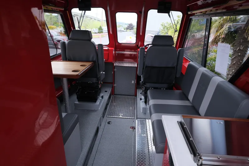 Slide: The Image of Interior of 2025 Hewescraft 250 Alaskan boat with seating and table. - 11