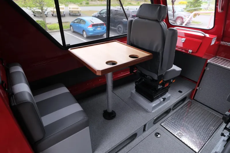 Slide: The Image of Interior of 2025 Hewescraft 250 Alaskan boat with seating and table setup. - 12