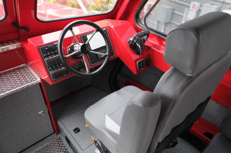 Slide: The Image of Interior of 2025 Hewescraft 250 Alaskan boat, featuring red dashboard and gray seating. - 14