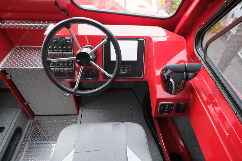 Slide: The Image of 2025 Hewescraft 250 Alaskan boat dashboard with steering wheel and control panel. - 15