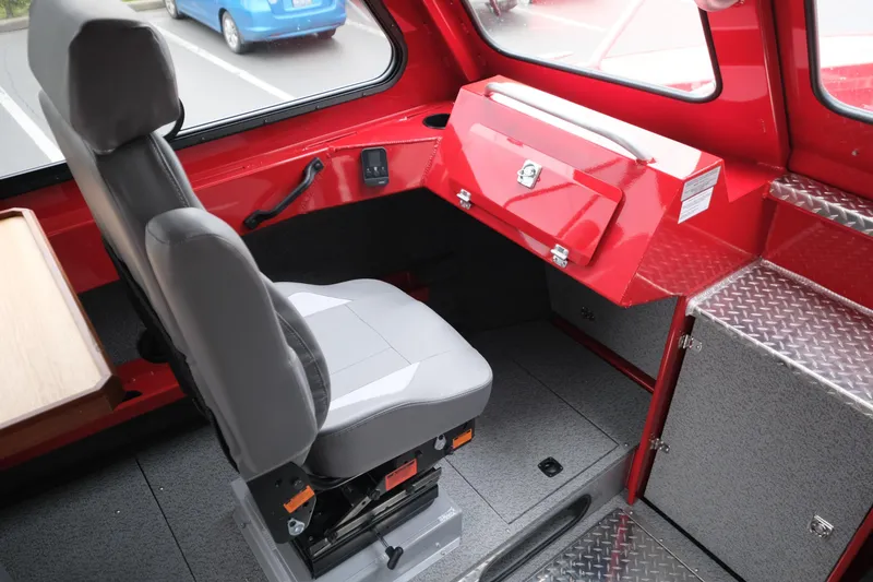 Slide: The Image of Interior of 2025 Hewescraft 250 Alaskan boat with gray seat and red storage compartment. - 17