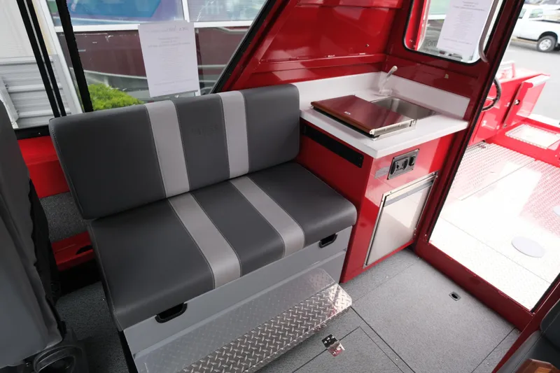 Slide: The Image of Interior of 2025 Hewescraft 250 Alaskan boat with seating and compact kitchenette. - 18