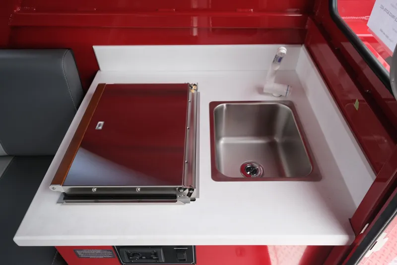 Slide: The Image of Compact kitchen area in 2025 Hewescraft 250 Alaskan boat, featuring a sink and stove. - 20