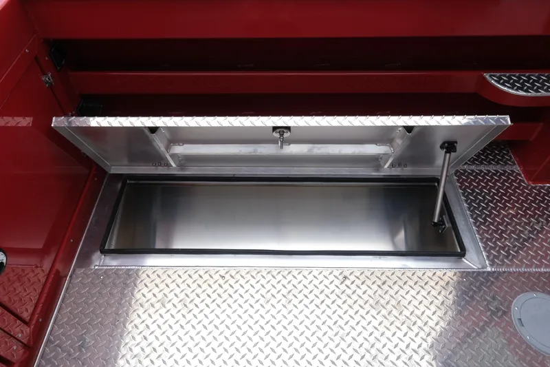 Slide: The Image of Open storage compartment on 2025 Hewescraft 250 Alaskan boat with diamond plate flooring. - 21