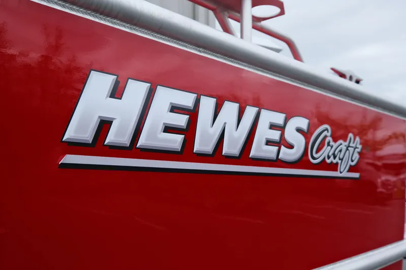Slide: The Image of 2025 Hewescraft 250 Alaskan boat logo on red exterior. - 23
