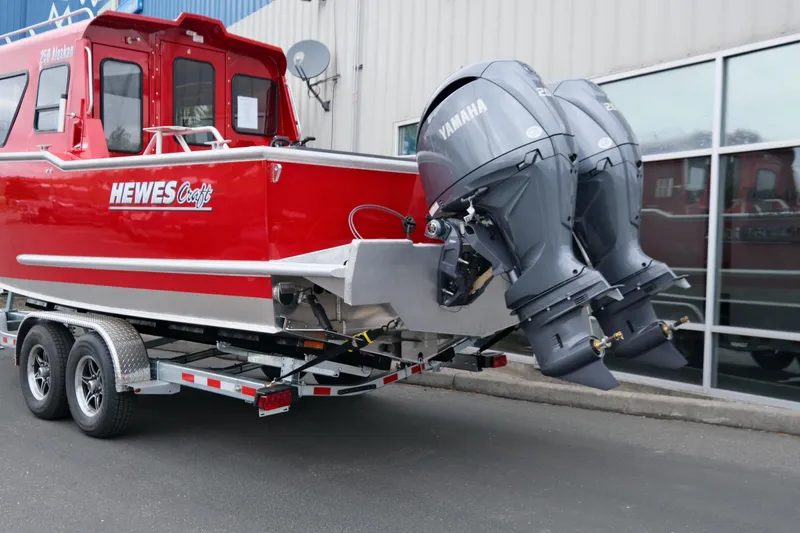 Slide: The Image of 2025 Hewescraft 250 Alaskan boat with dual Yamaha outboard motors on a trailer. - 5