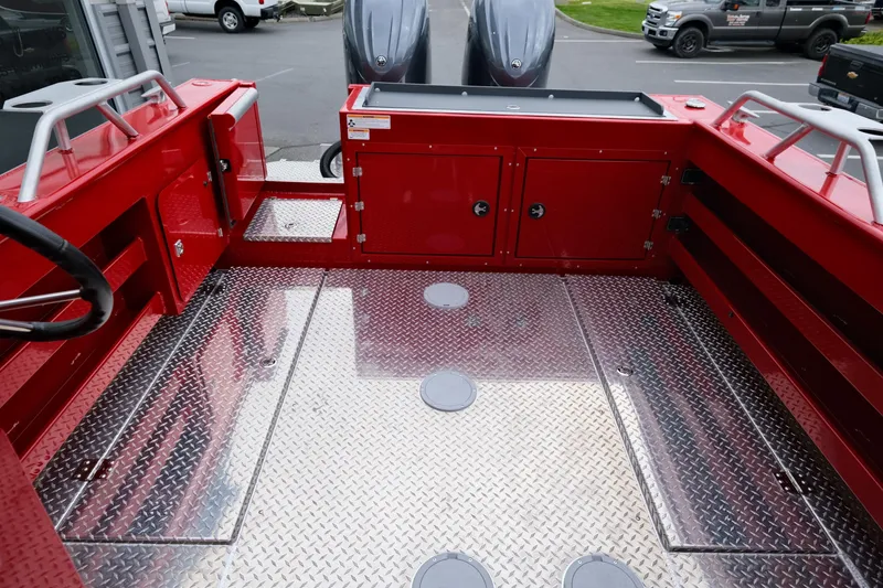 Slide: The Image of 2025 Hewescraft 250 Alaskan boat interior with red accents and diamond plate flooring. - 8