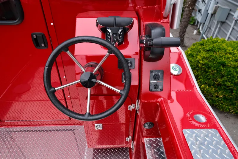 Slide: The Image of Red 2025 Hewescraft 250 Alaskan boat dashboard with steering wheel and controls. - 9