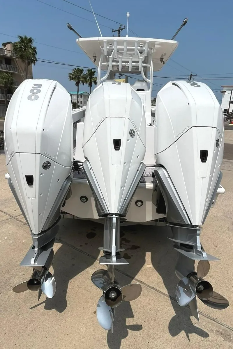 Slide: The Image of 2024 Reef Runner 340 boat with triple outboard engines. - 11