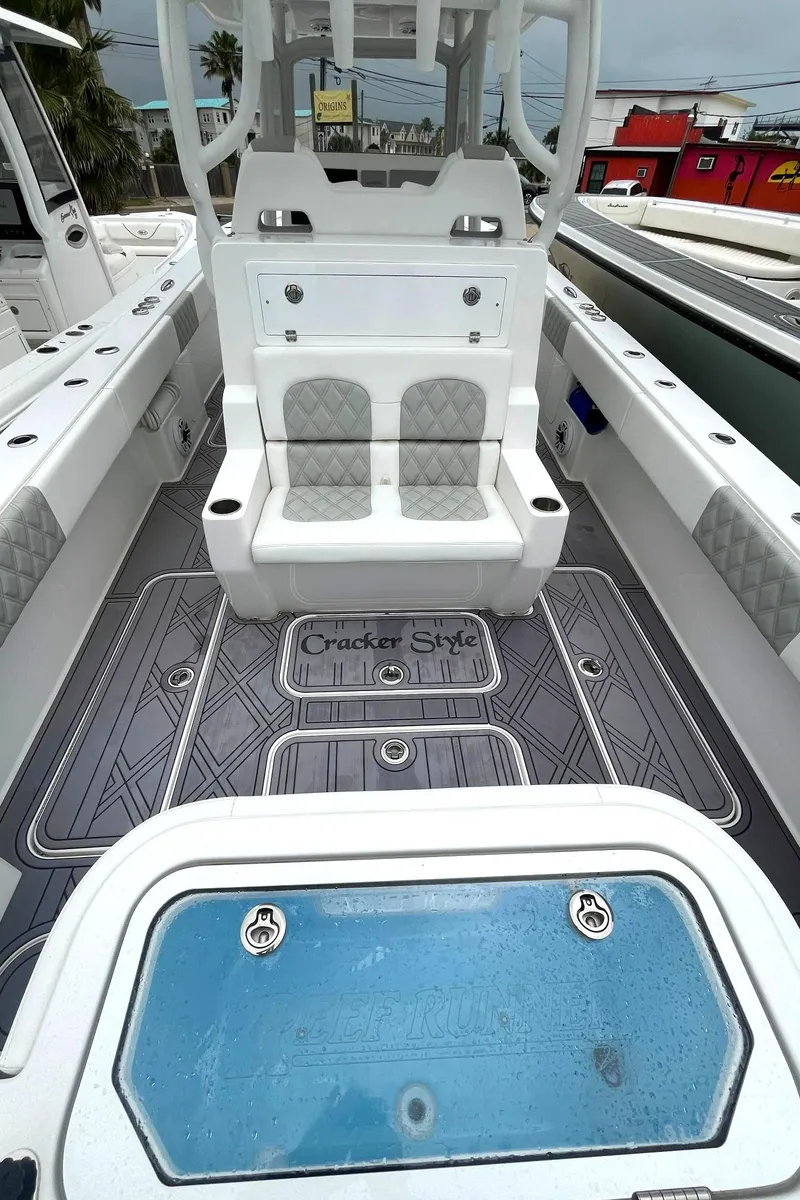 Slide: The Image of 2024 Reef Runner 340 boat interior with seating and storage compartments. - 3