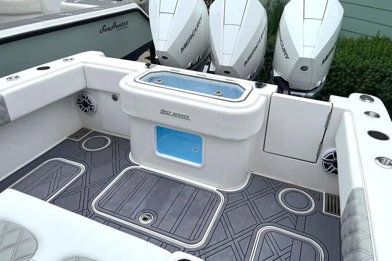 Slide: The Image of 2024 Reef Runner 340 boat deck with triple Mercury outboard engines. - 4