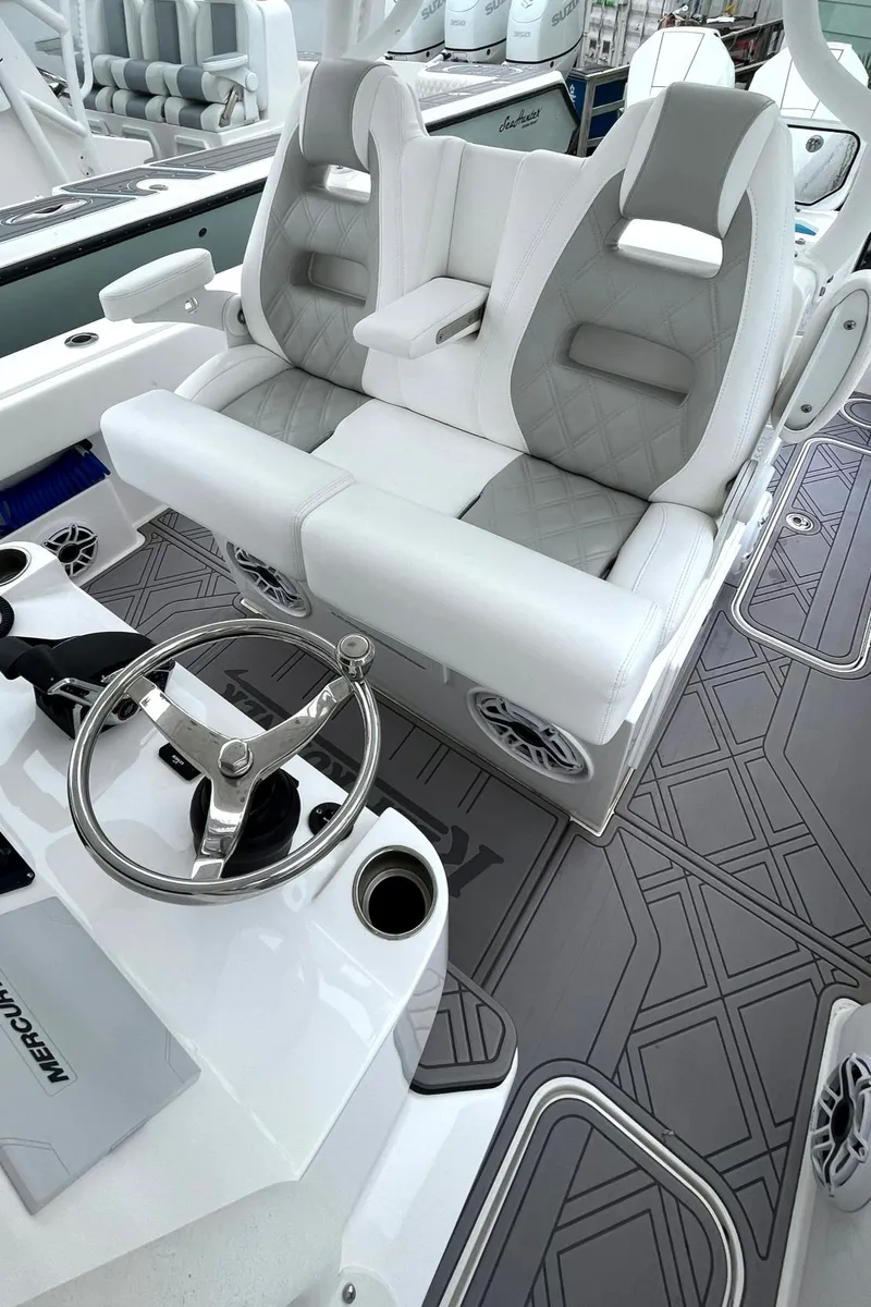 Slide: The Image of 2024 Reef Runner 340 boat interior with dual seating and modern steering console. - 8