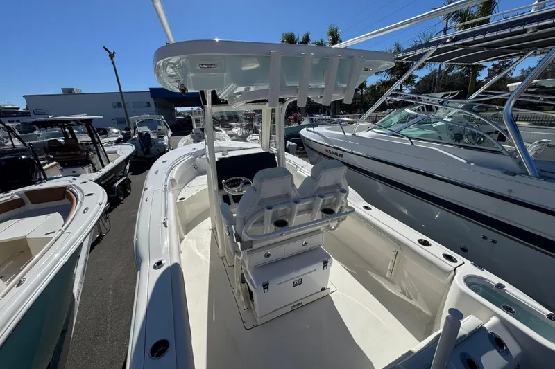 Slide: The Image of 2026 Key West 244 Center Console boat in marina, surrounded by other vessels. - 10