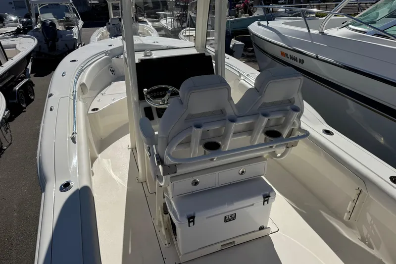 Slide: The Image of 2026 Key West 244 Center Console boat interior with dual seats and steering console. - 12