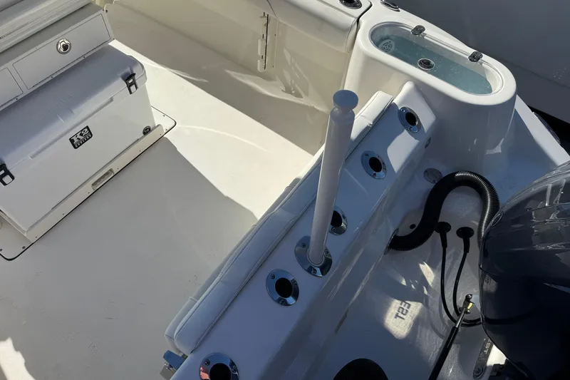 Slide: The Image of 2026 Key West 244 Center Console boat interior with storage and fishing rod holders. - 13
