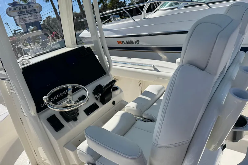 Slide: The Image of 2026 Key West 244 Center Console boat interior with steering wheel and seating. - 15