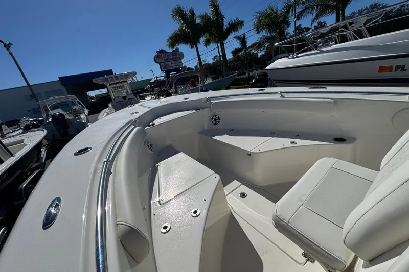 Slide: The Image of 2026 Key West 244 Center Console boat interior with seating, displayed at a dealership. - 22