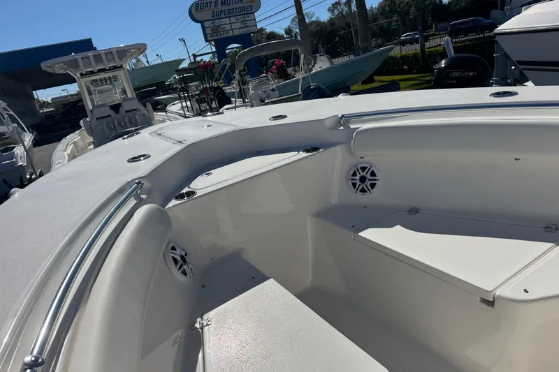 Slide: The Image of 2026 Key West 244 Center Console boat interior at dealership, showcasing seating and speakers. - 23
