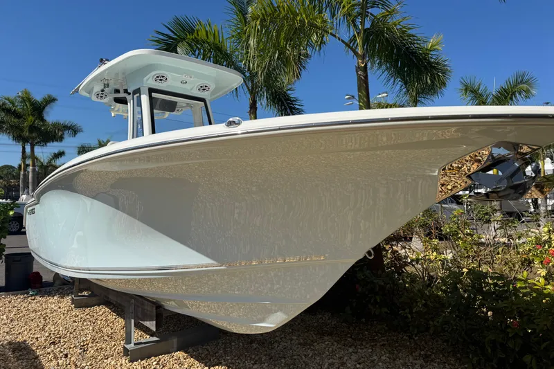 Slide: The Image of 2026 Key West 244 Center Console boat displayed outdoors with palm trees. - 3