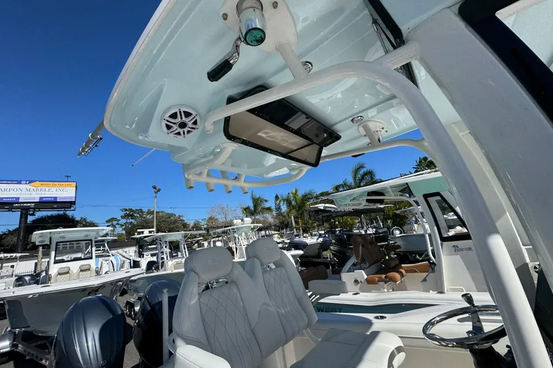 Slide: The Image of 2026 Key West 244 Center Console boat interior with seating and overhead electronics. - 32