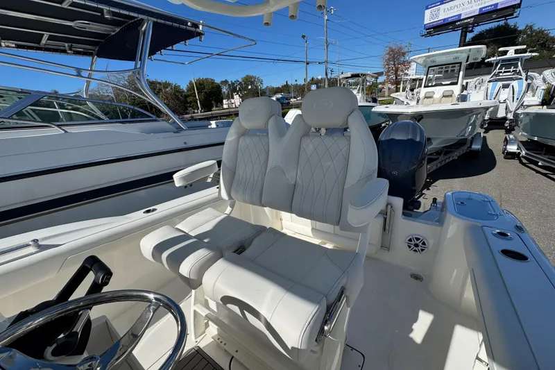 Slide: The Image of 2026 Key West 244 Center Console boat interior with plush seating and steering wheel. - 35