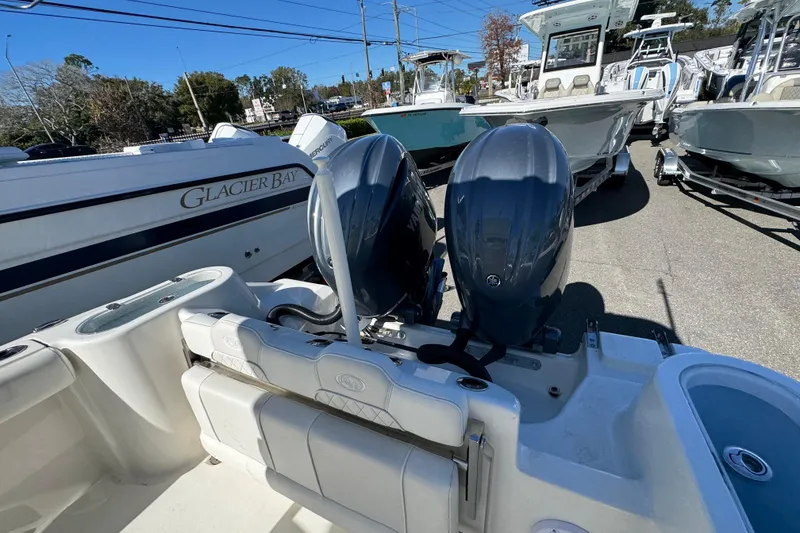 Slide: The Image of 2026 Key West 244 Center Console boat with dual outboard engines in a marina. - 38