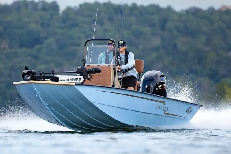 Slide: The Image of Manufacturer Provided Image: 2026 G3 Bay 21 GX boat cruising on a lake with two people onboard. - 1