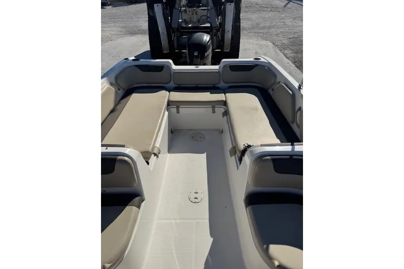 Slide: The Image of 2018 Bayliner Element E21 boat interior with beige seating and spacious layout. - 15