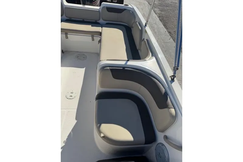 Slide: The Image of 2018 Bayliner Element E21 boat interior with beige and gray seating. - 16