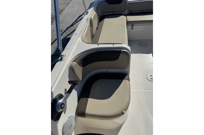 Slide: The Image of 2018 Bayliner Element E21 boat interior with beige seating and sleek design. - 17