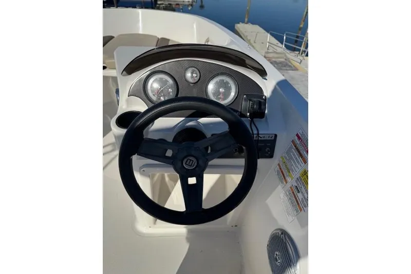 Slide: The Image of 2018 Bayliner Element E21 dashboard with steering wheel and gauges. - 19