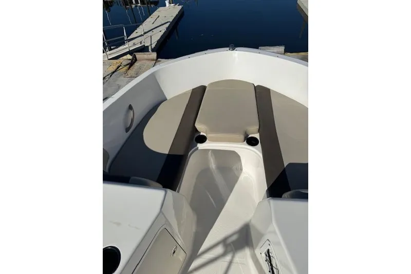 Slide: The Image of 2018 Bayliner Element E21 boat interior with beige seating and cup holders. - 20