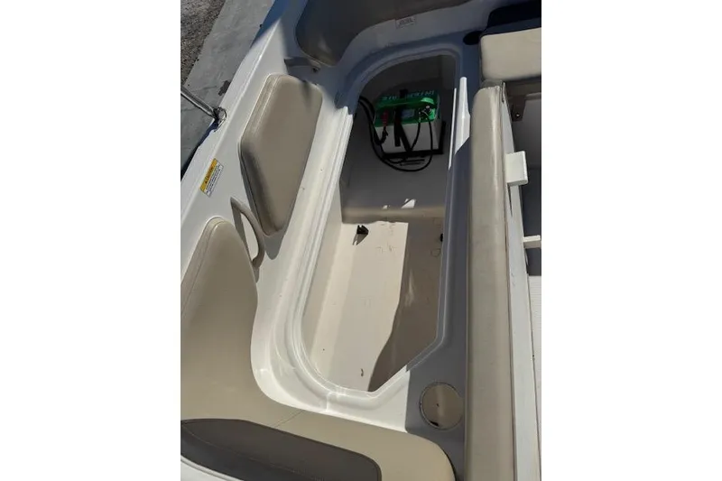 Slide: The Image of 2018 Bayliner Element E21 boat interior storage compartment with battery. - 22