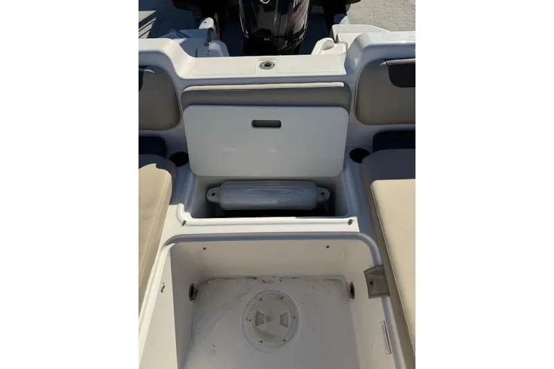 Slide: The Image of 2018 Bayliner Element E21 boat interior with storage compartments and seating. - 23