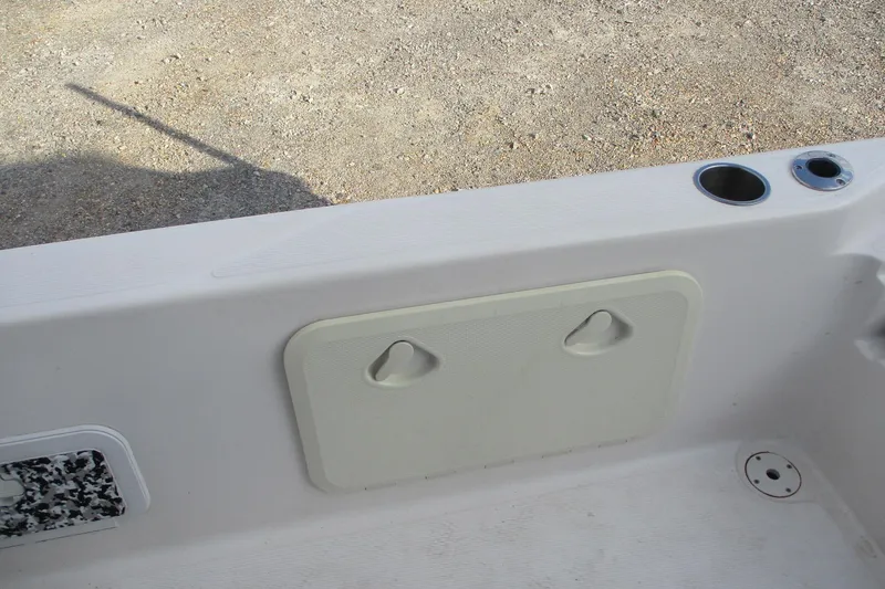 Slide: The Image of 2019 Blue Wave 2200 SL BAY boat interior with storage compartment and cup holders. - 10