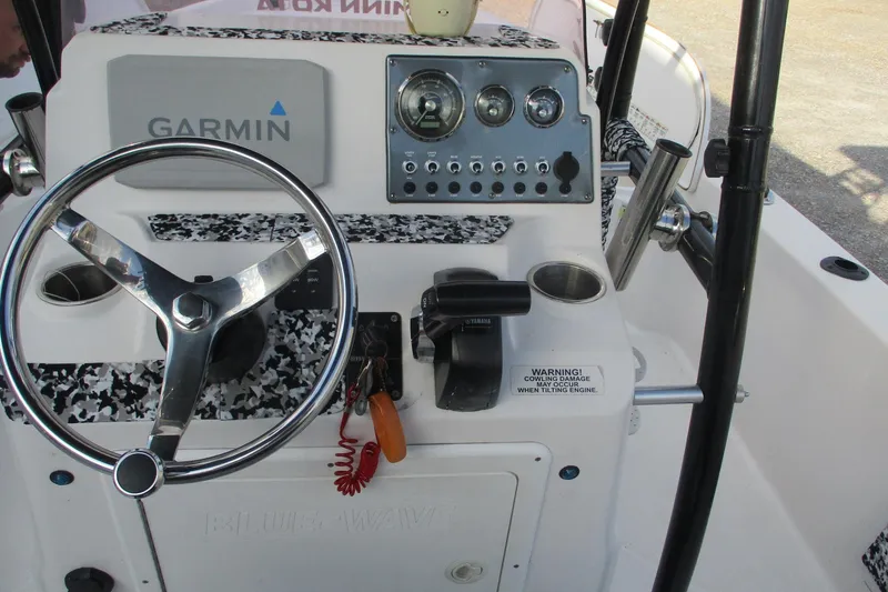 Slide: The Image of 2019 Blue Wave 2200 SL BAY boat console with Garmin navigation and steering wheel. - 15