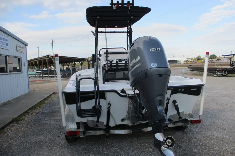 Slide: The Image of 2019 Blue Wave 2200 SL BAY boat with Yamaha 150 engine, parked outdoors. - 4