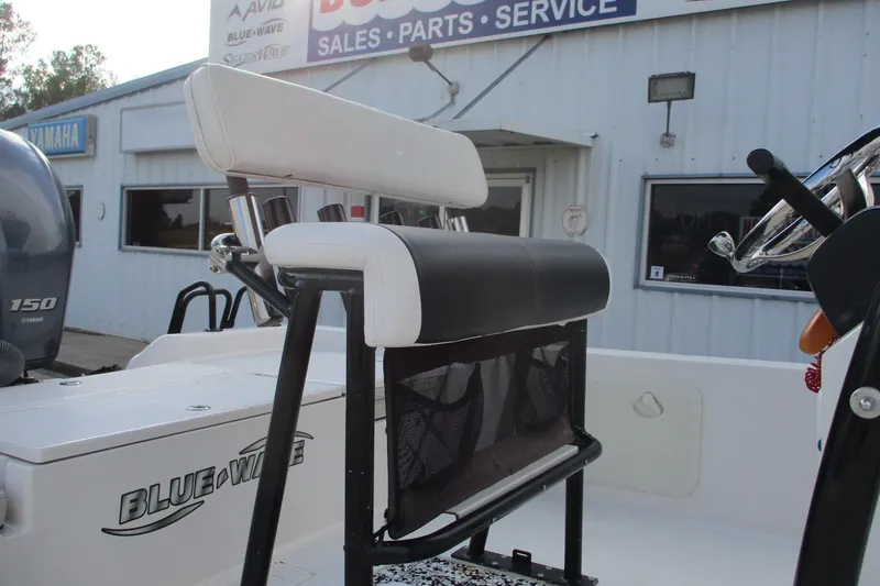 Slide: The Image of 2019 Blue Wave 2200 SL BAY boat with seating, near sales and service building. - 9