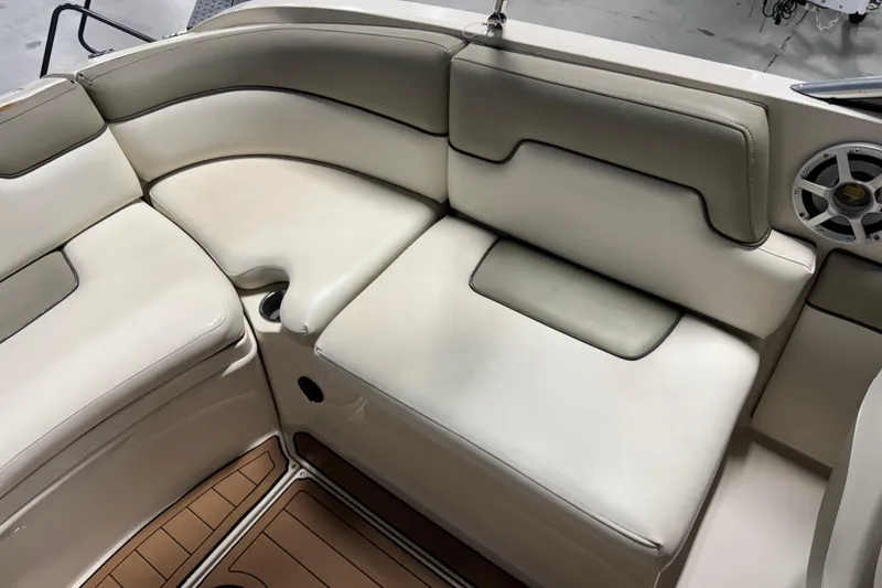 Slide: The Image of 2007 Sea Ray 260 Sundeck interior with white cushioned seating and speaker. - 10