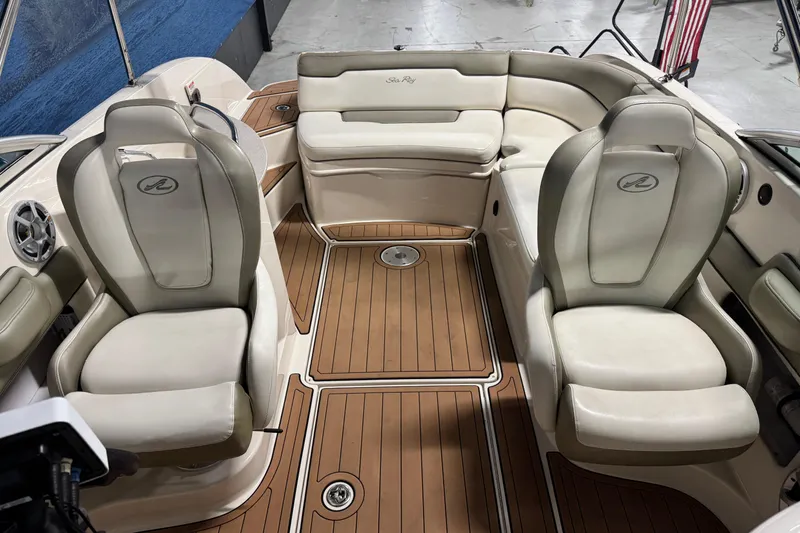Slide: The Image of 2007 Sea Ray 260 Sundeck interior with beige seating and wood-style flooring. - 12