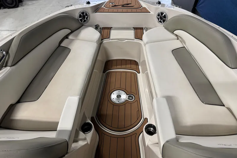 Slide: The Image of 2007 Sea Ray 260 Sundeck interior with cushioned seating and wood-style flooring. - 15