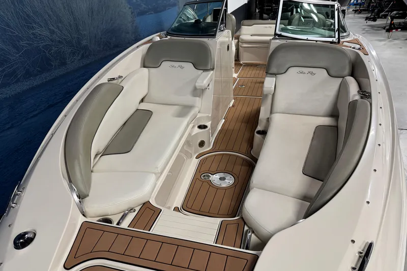 Slide: The Image of 2007 Sea Ray 260 Sundeck interior with beige seating and wood accents. - 16