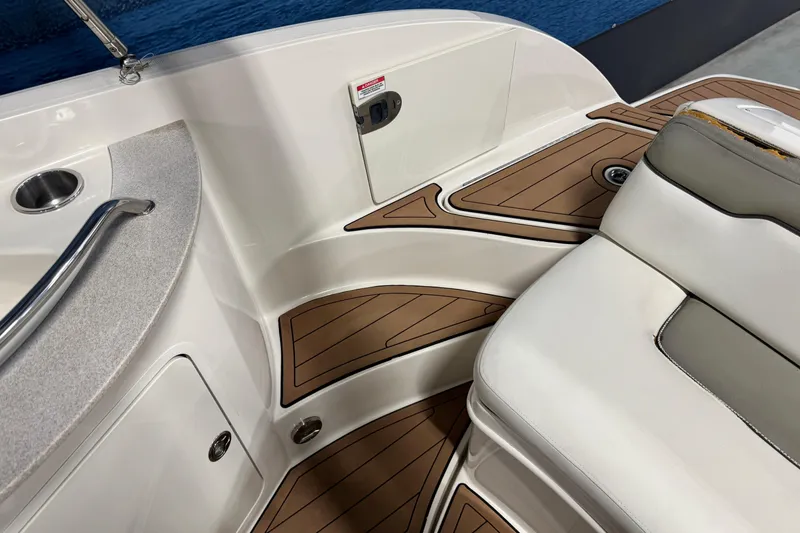 Slide: The Image of 2007 Sea Ray 260 Sundeck interior with cushioned seating and wood-style flooring. - 9