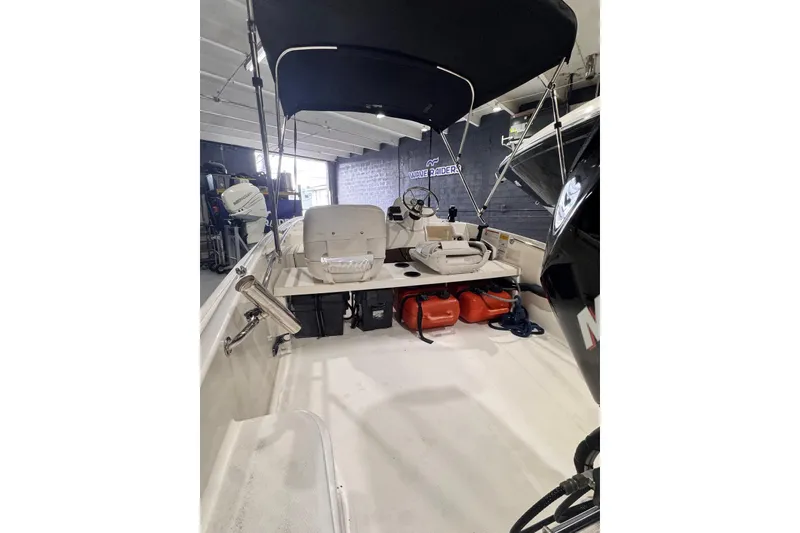 Slide: The Image of 2011 Boston Whaler 160 Super Sport boat interior with canopy and seating. - 3
