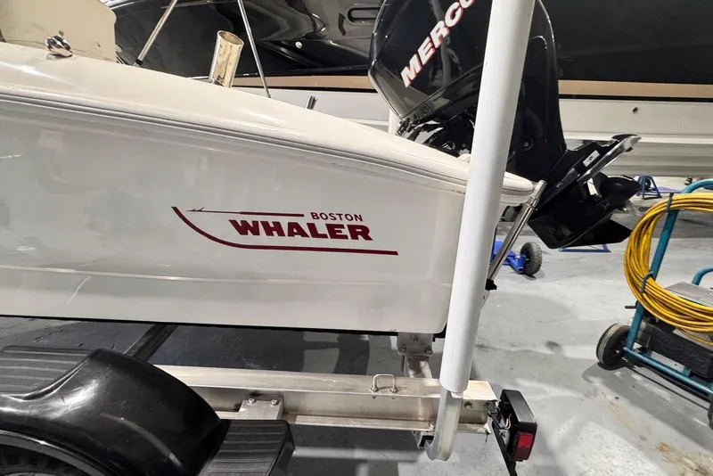 Slide: The Image of 2011 Boston Whaler 160 Super Sport boat on trailer with Mercury outboard motor. - 7