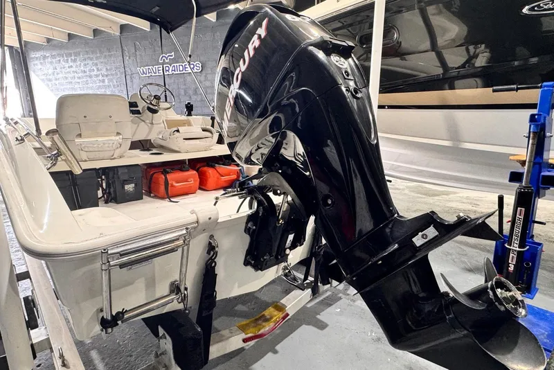 Slide: The Image of 2011 Boston Whaler 160 Super Sport with Mercury outboard engine in a garage. - 9