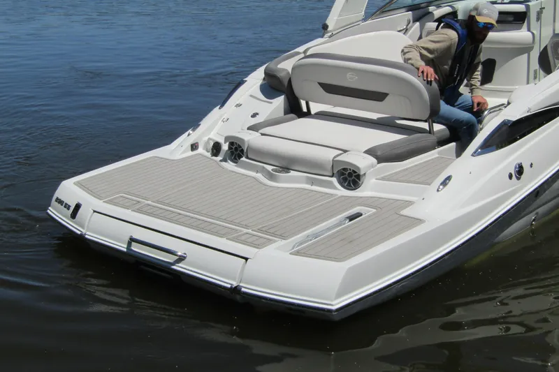 Slide: The Image of 2026 Crownline 288 SS boat with spacious deck and seating on water. - 1