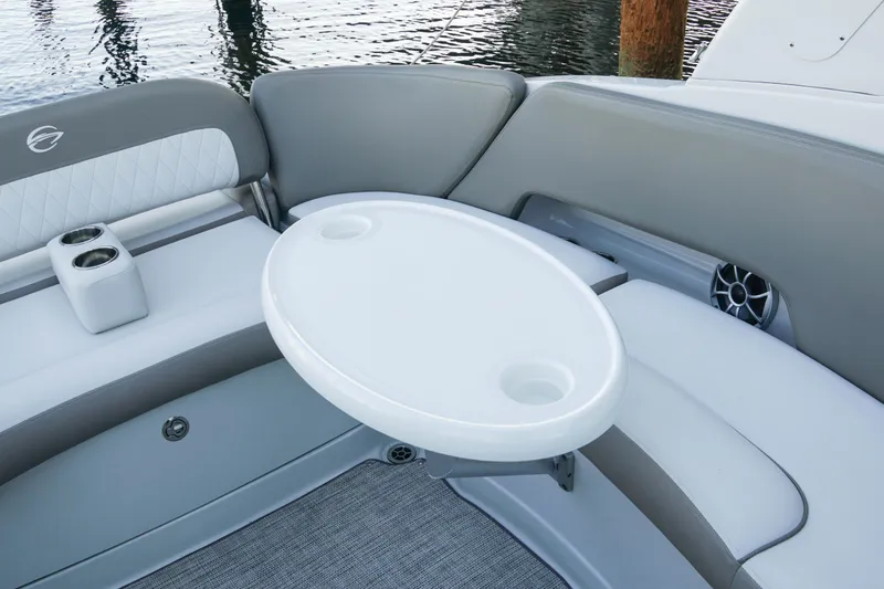 Slide: The Image of Luxury seating area on 2026 Crownline 288 SS boat with table and cup holders. - 10